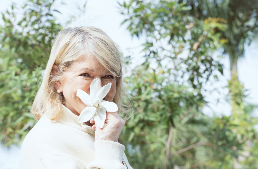 Martha Stewart holds a tropical gardenia at Naples Botanical Garden