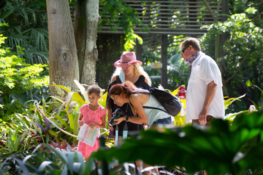 A family completes a W.O.N.D.E.R. Pack activity in the Garden.